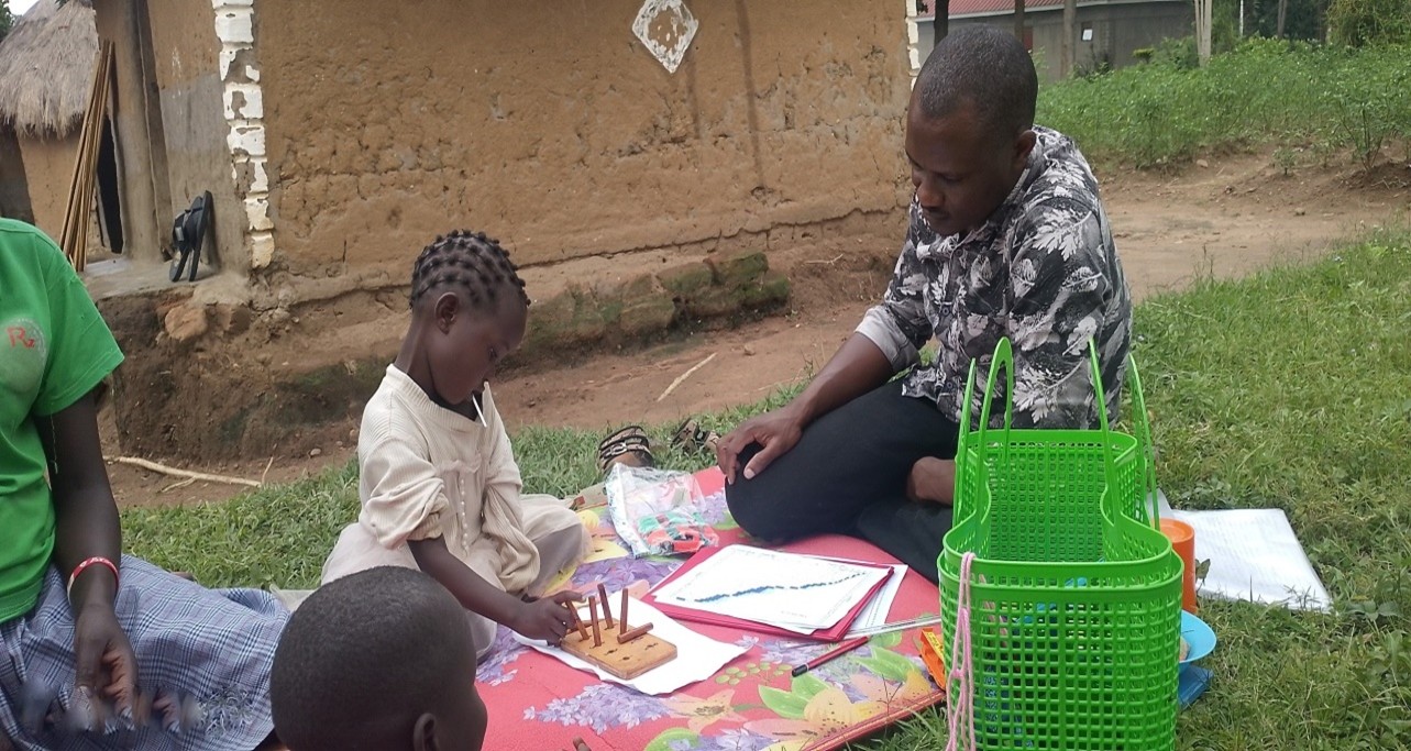 A father playing with his daughter in Tororo.