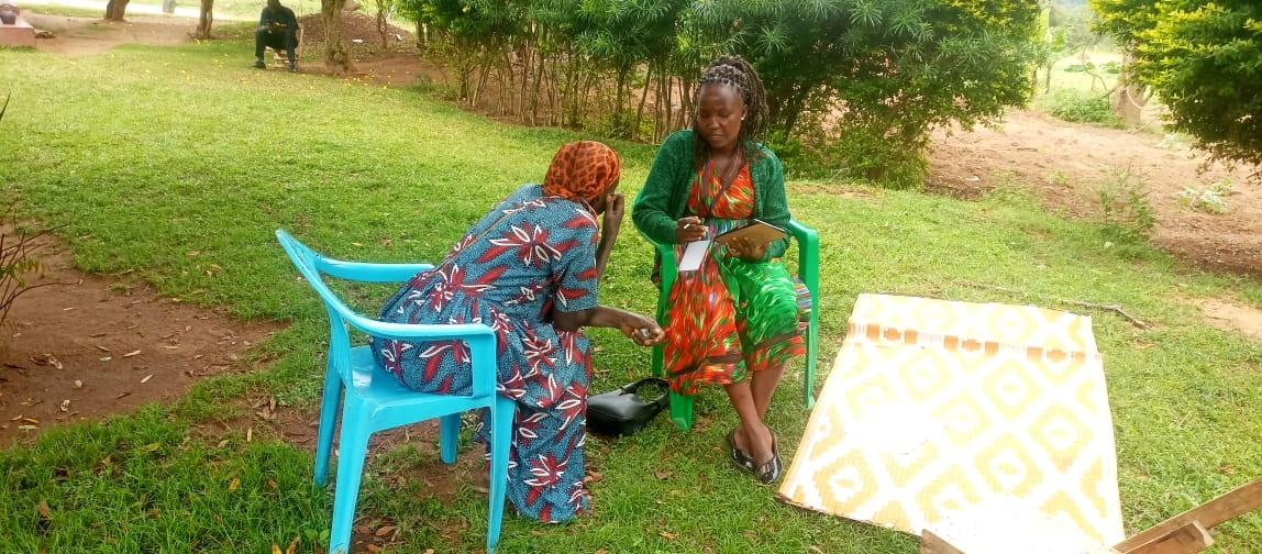 A beneficiary parent shares a testimony with a Research Assistant.